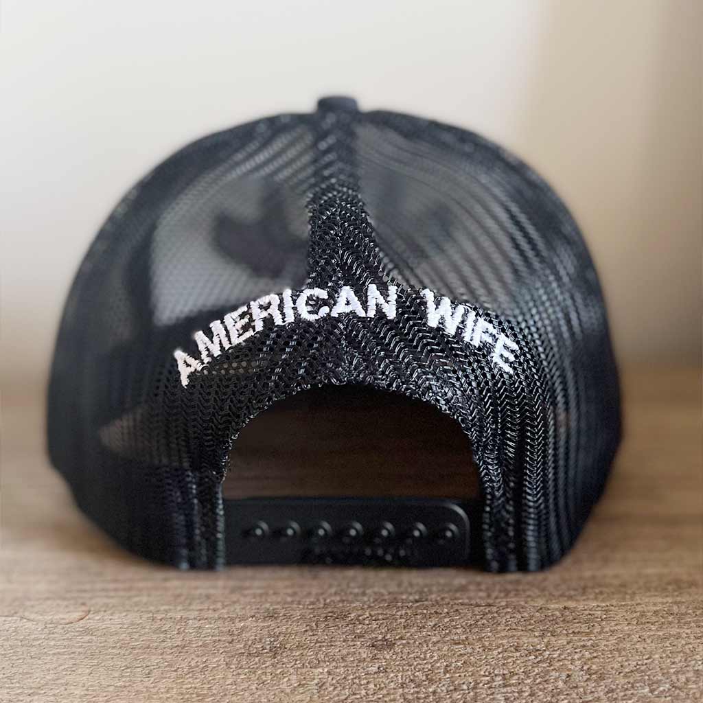 backside of black snapback mesh mat with a white American Wife embroidered