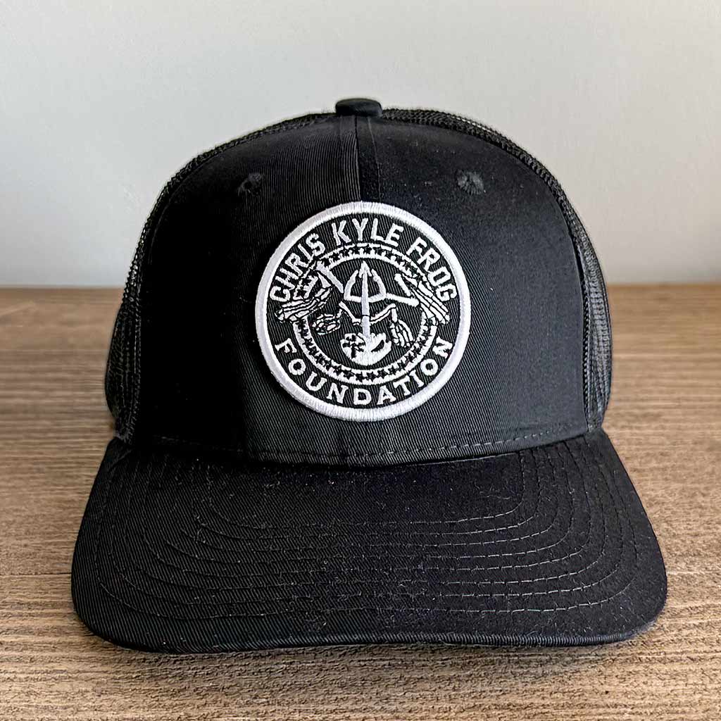 Black hat with white embroidered Chris Kyle Frog Foundation circle logo